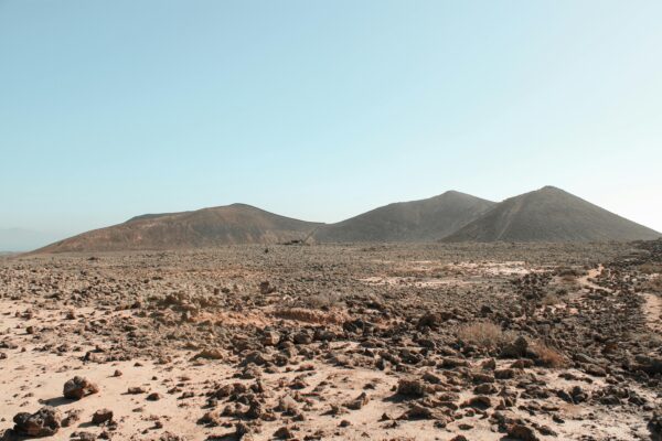 Stunning arid landscape with volcanic mountains and blue sky in La Oliva, Spain.